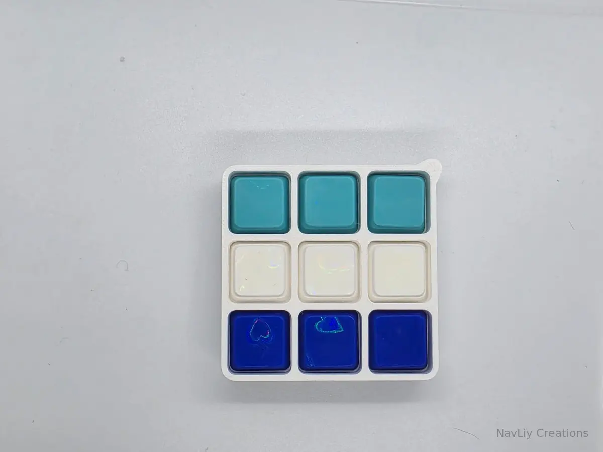 White keyboard fidget with teal, white, and blue keycaps